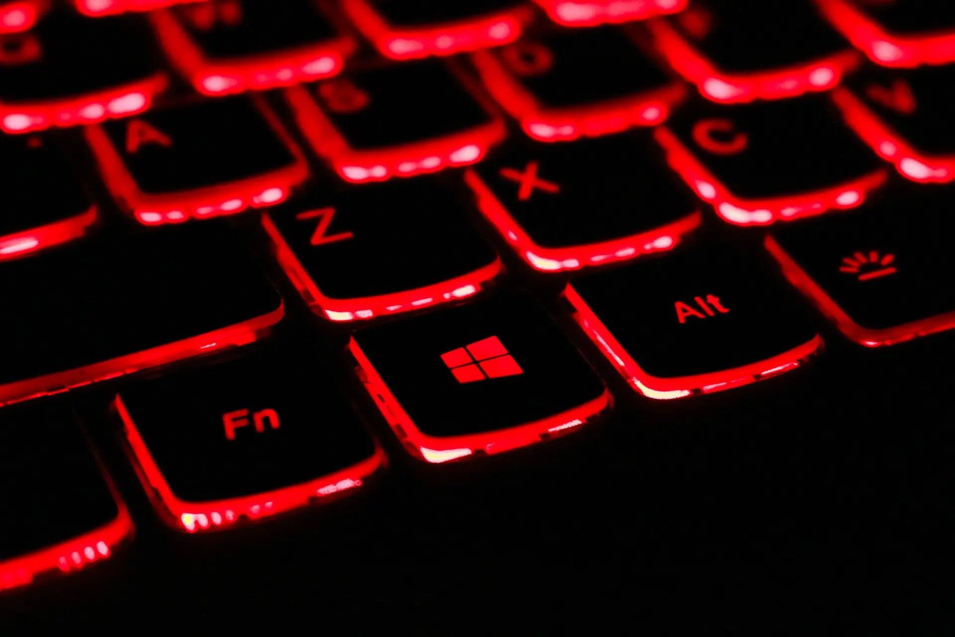 A keyboard with a red backlight.