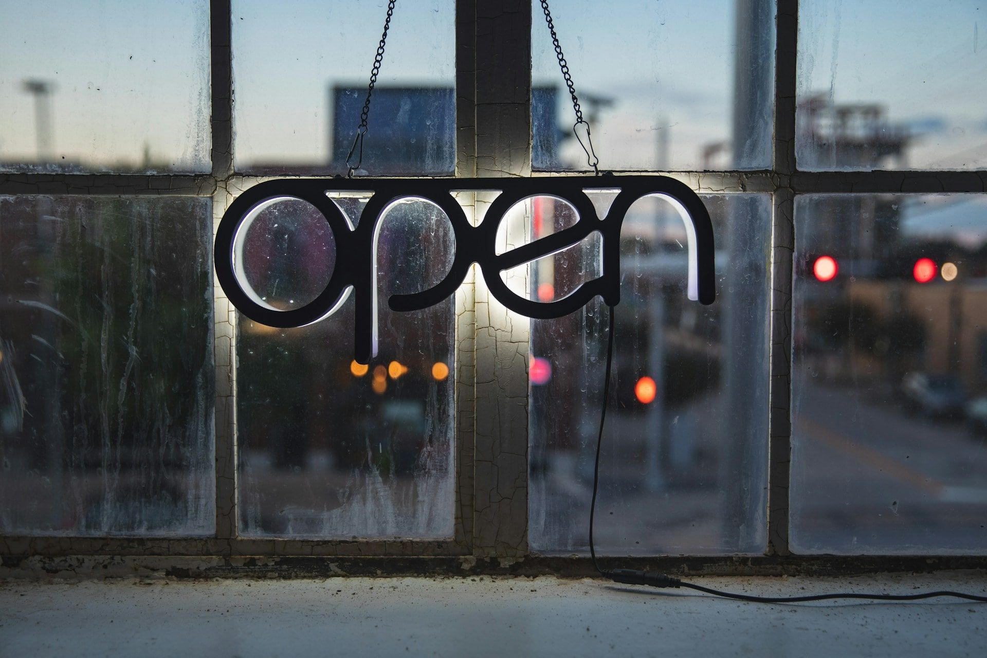 The word open displayed on a metal fence.